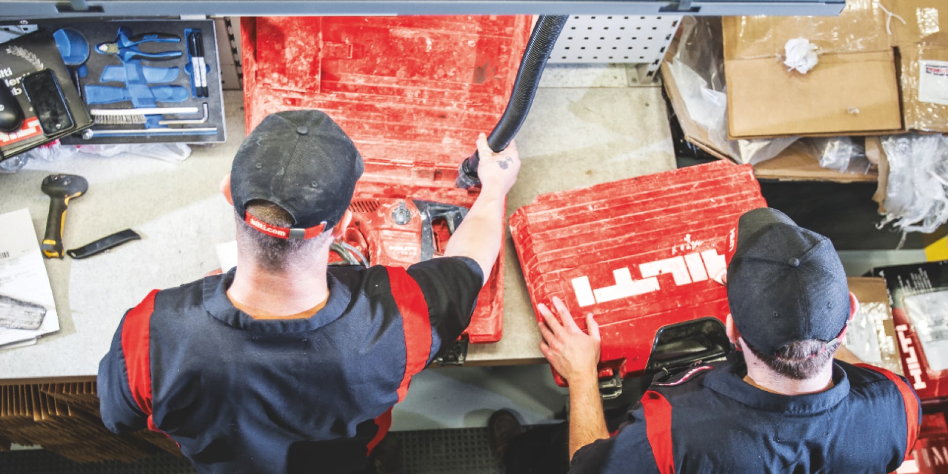 Two Hilti employees repairing a rotary hammer